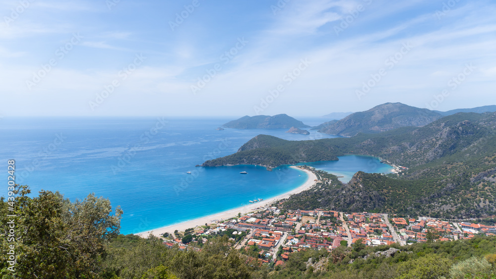 Miracle see view from mountains. Charming small peninsulas in the sea near the beach. Blue sea and sky and green islands