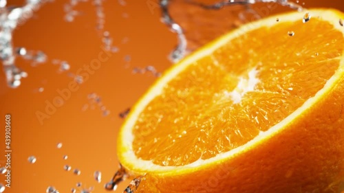 Super slow motion of orange slice with water splashing around. Filmed on high speed cinema camera, 1000 fps.