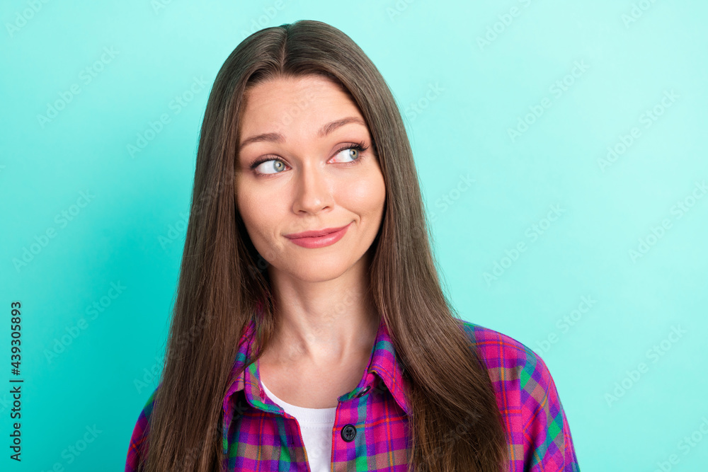 Portrait of attractive curious girl wearing checked shirt thinking copy space isolated over bright teal green color background Portrait of attractive curious girl wearing checked shirt thinking copy space isolated over bright teal green color background