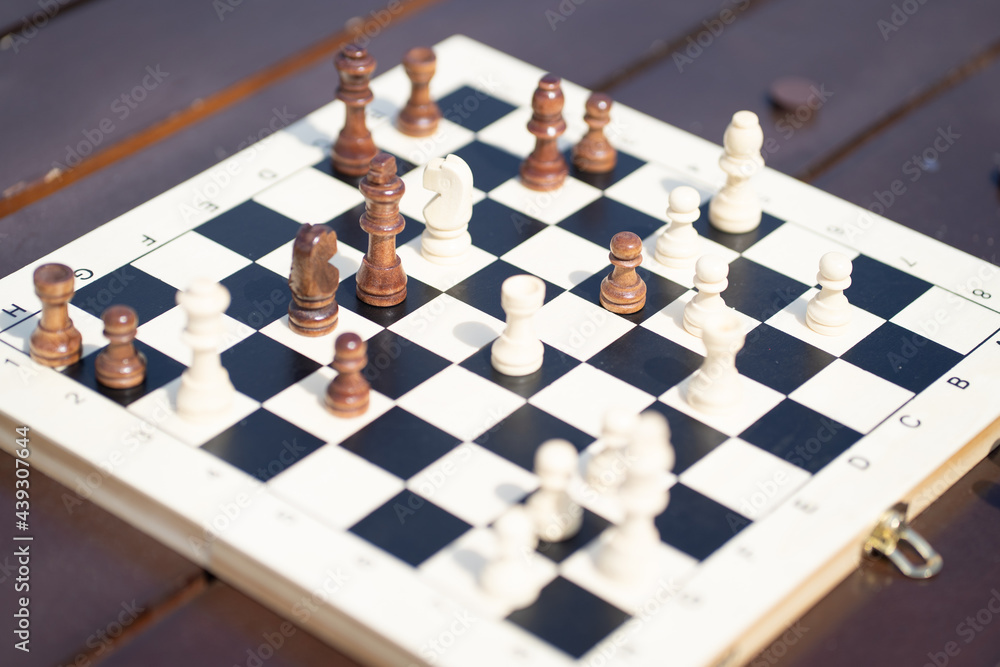 Game of chess. Chess board during the game. Black and white chess field. People play chess in the street Game of chess. Chess board during the game. Black and white chess field. People play chess in the street