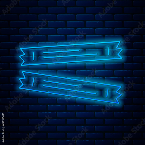 Glowing neon line Sugar stick packets icon isolated on brick wall background. Blank individual package for bulk food products as coffee, salt, spices. Vector