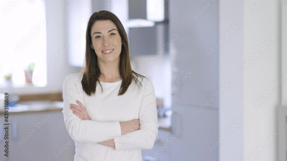 Confident housewife standing at home with arms crossed Confident housewife standing at home with arms crossed
