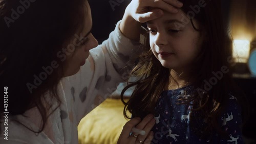 Young mother taking care of her sick daughter