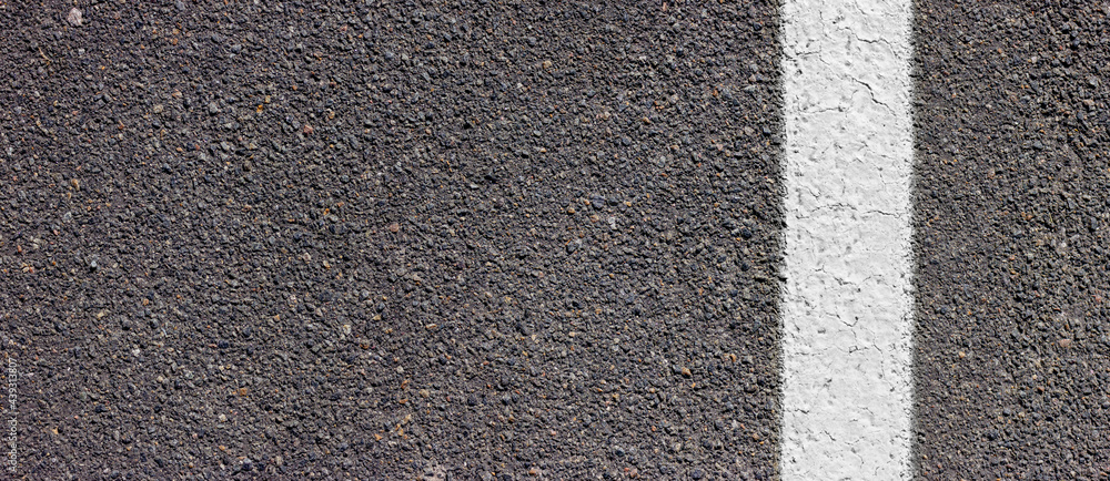 Asphalt texture with white line on the right side. Road surface with markings.