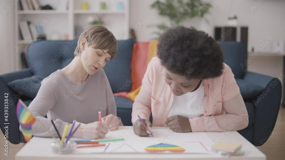 Female activists drawing lgbt pride parade posters, human rights protection Female activists drawing lgbt pride parade posters, human rights protection