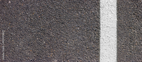 Asphalt texture with white line on the right side. Road surface with markings.