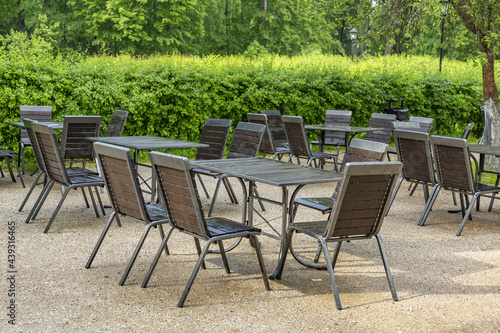 Vacant table and chairs of an outdoor street cafe without people as a symbol of the economic crisis © ironstuffy