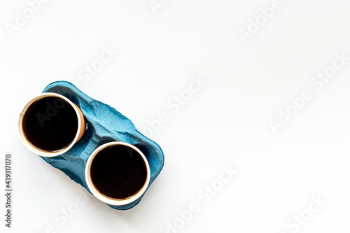 Take away black coffee on the table. Top view