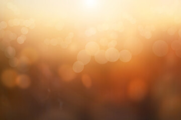 An autumn blurred abstract nature background image of a golden yellow and  brown autumn landscape at sunset.