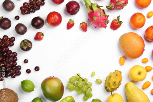 Frame of different delicious exotic fruits on white background, flat lay. Space for text
