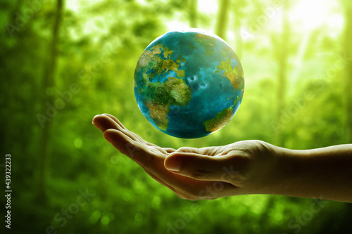Human hand holding planet earth photo