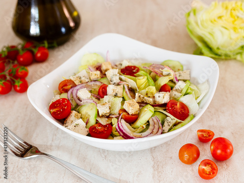 Greek vegan salad with lettuce, tomatoes, tofu, cucumber, onion. Healthy food