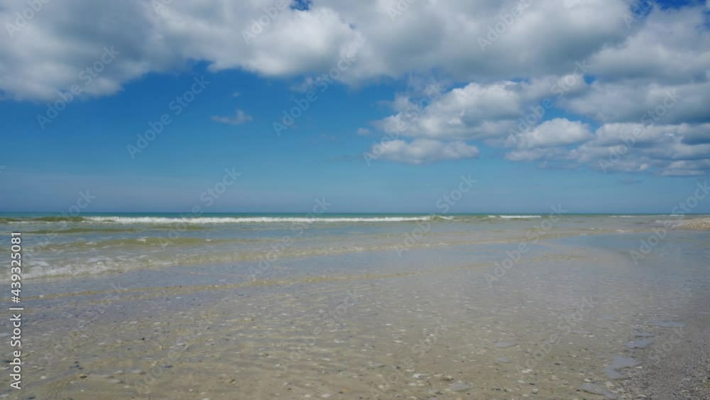 A beautiful seashore or ocean, majestic clouds in the blue sky, clear and transparent water on a sunny day. A place of rest and relaxation. A beautiful seashore or ocean, majestic clouds in the blue sky, clear and transparent water on a sunny day. A place of rest and relaxation.