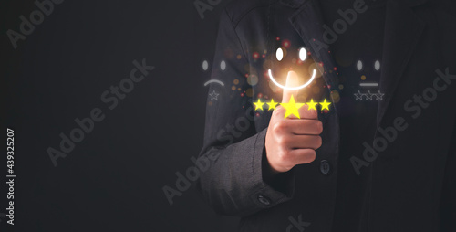 Satisfaction survey concept. Customer service evaluation Business people or customers show satisfaction through the application on the tablet screen. By giving the most satisfaction rating and 5 star.