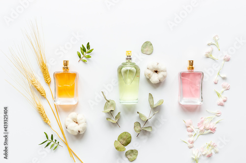 Floral fragrance - perfume bottles with flowers, top view