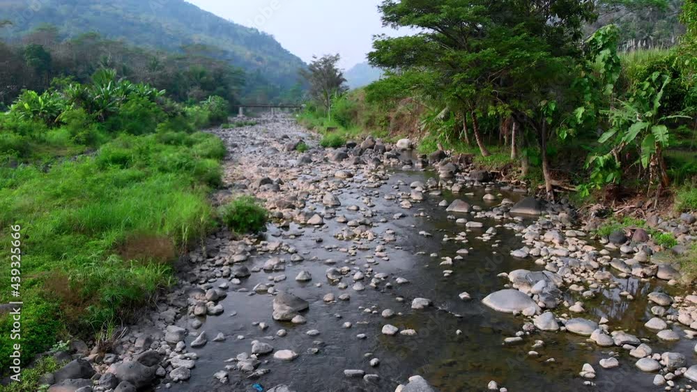 Beautiful riverside landscape view with rocks boulder and small water flow Beautiful riverside landscape view with rocks boulder and small water flow