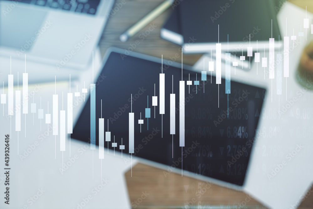 Multi exposure of abstract financial graph and modern digital tablet on desktop on background, top view, financial and trading concept Multi exposure of abstract financial graph and modern digital tablet on desktop on background, top view, financial and trading concept