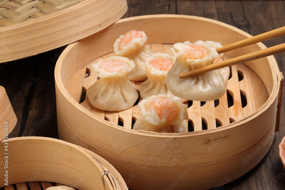 Prawn shrimp shaomai pickup by chopsticks Xiao long bao dim sum