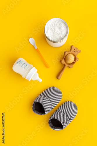 Feeding baby with milk formula - bottle of milk top view