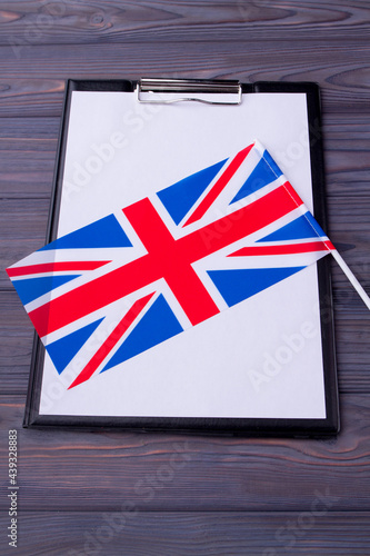 Flag of the United Kingdom and clipboard with blank paper for copy space.