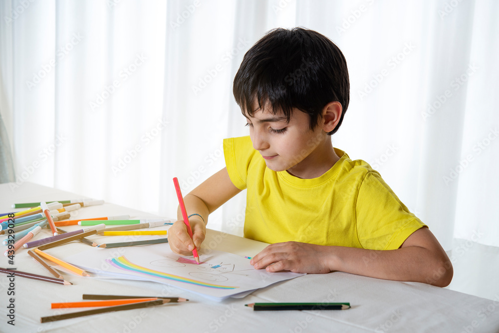 kid draws his family on a piece of paper with colored pencils. Concept of child psychology kid draws his family on a piece of paper with colored pencils. Concept of child psychology