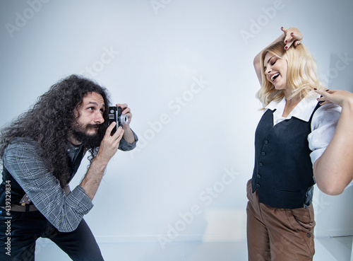 Funny hipster couple posing on white background