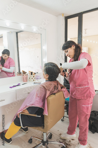 Adult woman getting a haircut.