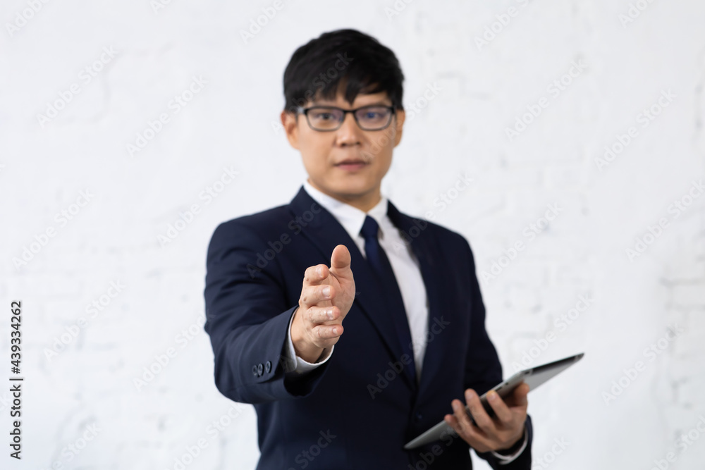 Asian business man giving hand for handshake. Successful businessmen handshaking after good deal Asian business man giving hand for handshake. Successful businessmen handshaking after good deal