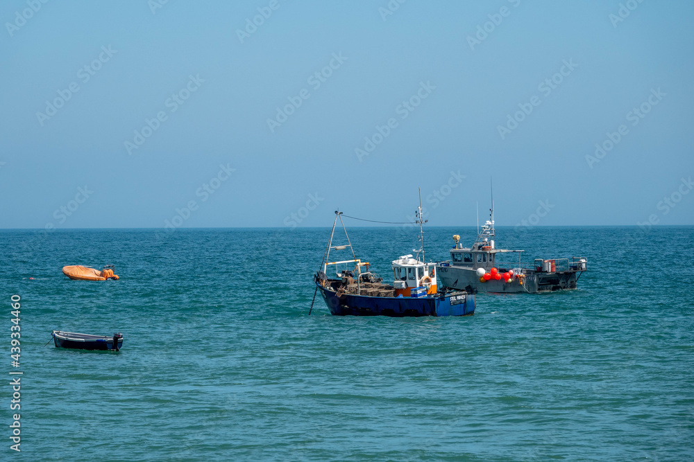fishing trawlers at anchor in the sea on a bright spring day