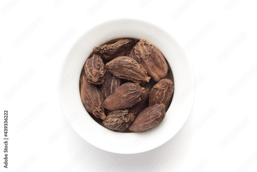 Macro close-up of Organic Black cardamom (Amomum subulatum) on white background. Pile of Indian Aromatic Spice. Top view Macro close-up of Organic Black cardamom (Amomum subulatum) on white background. Pile of Indian Aromatic Spice. Top view