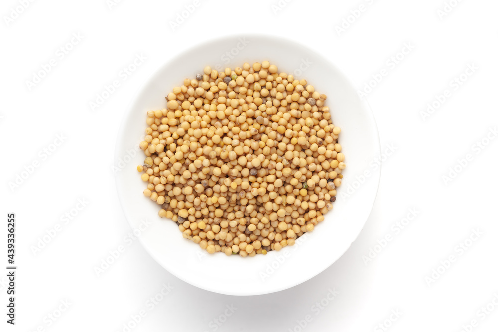 Macro close-up of Organic Mustard seed (Sinapis alba) on white background. Pile of Indian Aromatic Spice. Top view