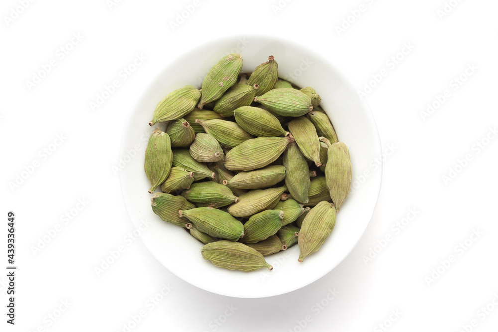 Macro close-up of Organic Cardamom or cardamum (Elettaria cardamomum) on white background. Pile of Indian Aromatic Spice. Top view Macro close-up of Organic Cardamom or cardamum (Elettaria cardamomum) on white background. Pile of Indian Aromatic Spice. Top view