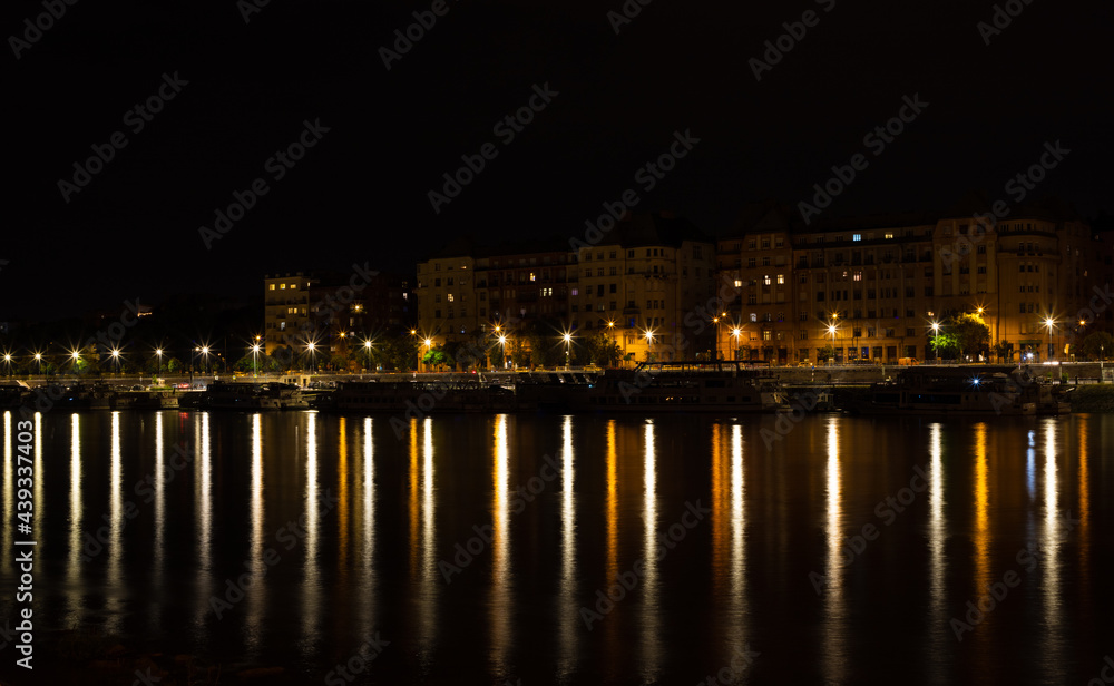 landscape with city lights reflected in the lake water