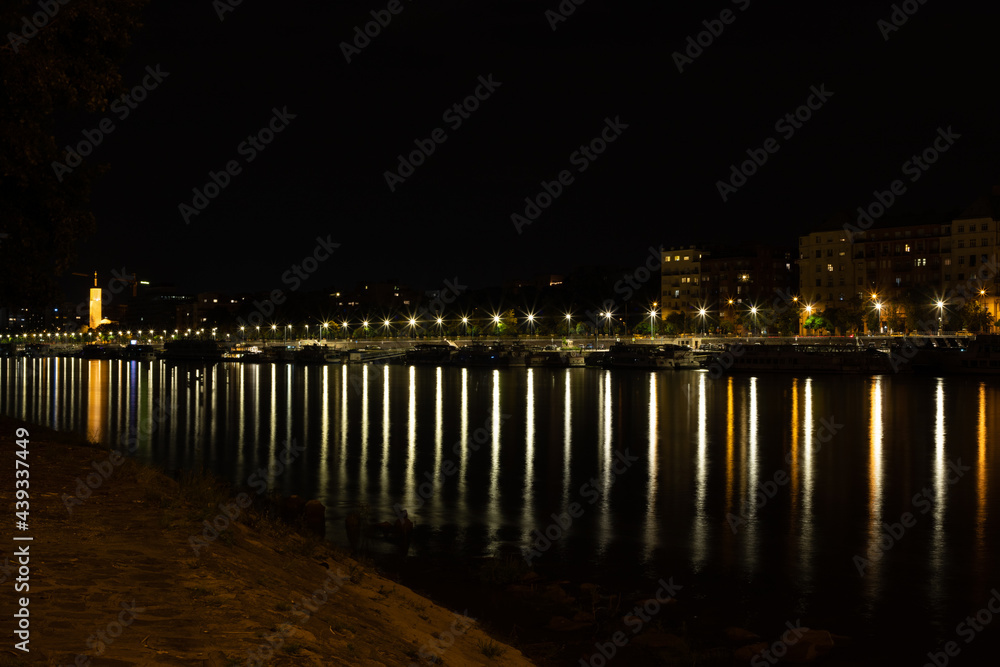 landscape with city lights reflected in the lake water