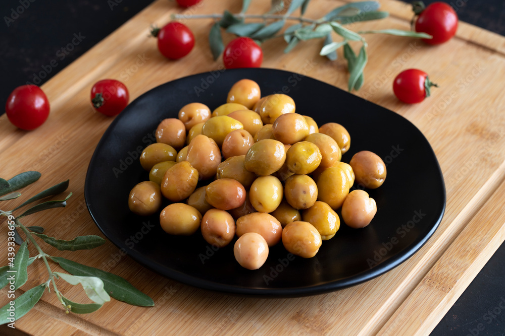 Delicious green olives. Tasty green olives in the plate. Delicious green olives. Tasty green olives in the plate.