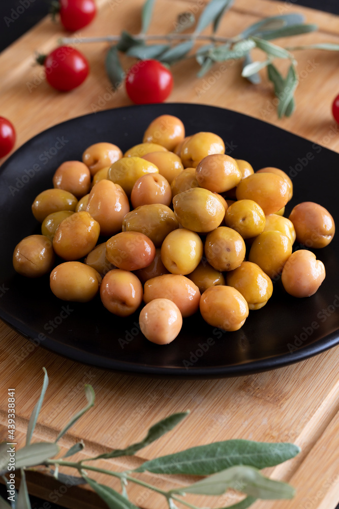 Delicious green olives. Tasty green olives in the plate. Delicious green olives. Tasty green olives in the plate.