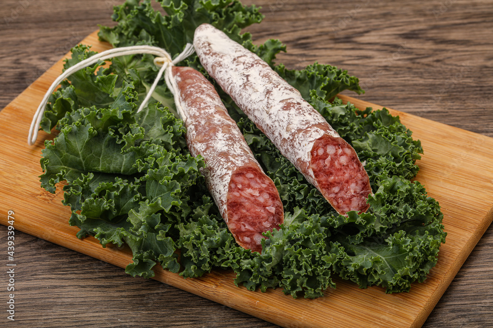 Spanish Fuet sausage with salad leaves Spanish Fuet sausage with salad leaves