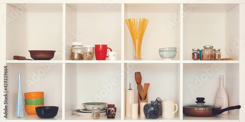 Modern interior. Open cupboard with clean dishes. Open shelves in the kitchen.