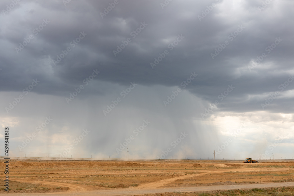 Cumulonimbus storm clouds and heavy rain over Kazakh steppe.