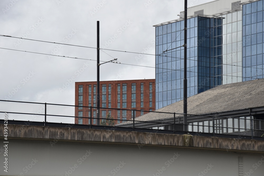 Looking up at modern buildings with a cloudy sky background. Taken in Manchester England. Looking up at modern buildings with a cloudy sky background. Taken in Manchester England.