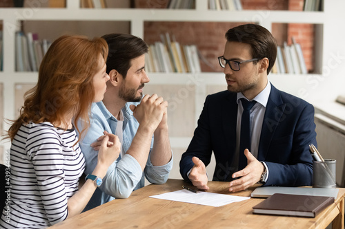 Принти на полотні Professional male lawyer financial advisor consulting happy family couple clients in modern office