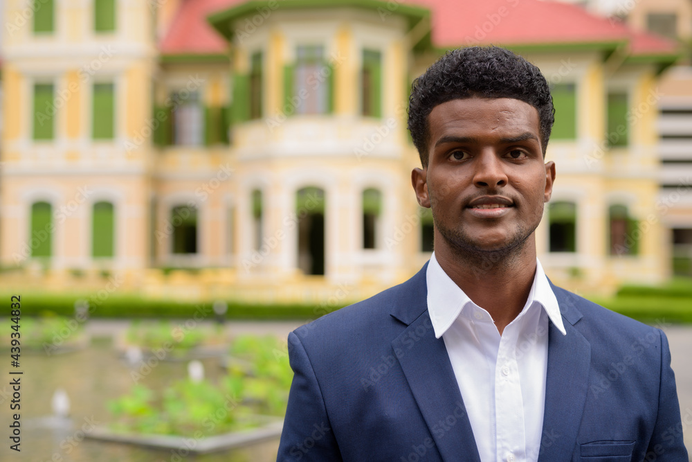 Portrait of African businessman outdoors wearing suit and looking at camera Portrait of African businessman outdoors wearing suit and looking at camera