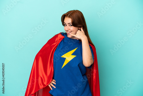 Young caucasian woman isolated on white background in superhero costume and doing phone gesture
