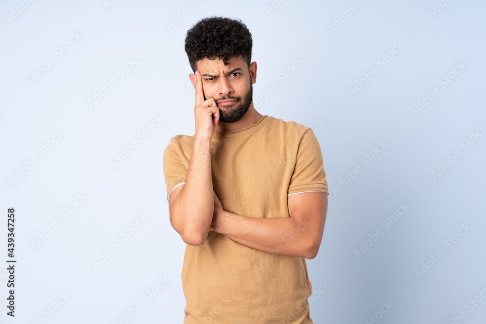 Young Moroccan man isolated on blue background thinking an idea Young Moroccan man isolated on blue background thinking an idea