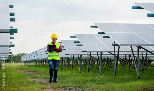 A young female solar cell engineer is working hard. Working in alternative energy Solar energy