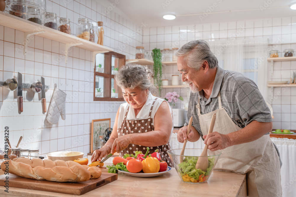 Lovely couple Asian elder happy and smiling cooking salad together for breakfast in the morning at home kitchen Lovely couple Asian elder happy and smiling cooking salad together for breakfast in the morning at home kitchen