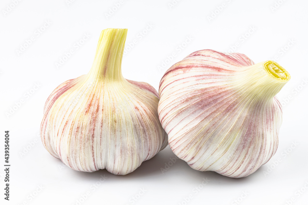 Obraz premium Two large heads of garlic isolated on a white background.