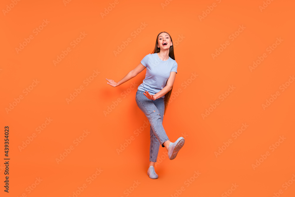 Full body photo of young cheerful girl happy positive smile have fun excited dance party isolated over orange color background