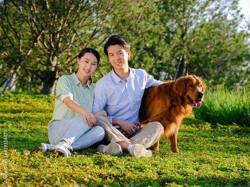 Young couple and pet dog in the park