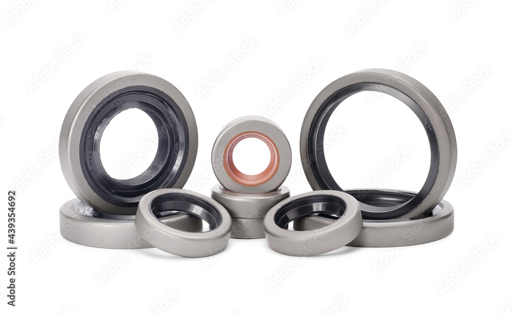 Group of rubber reinforced oil seals for shafts and for car motor engines, isolated on white background. Cuffs for prevent liquid leak. Car parts. Group of rubber reinforced oil seals for shafts and for car motor engines, isolated on white background. Cuffs for prevent liquid leak. Car parts.